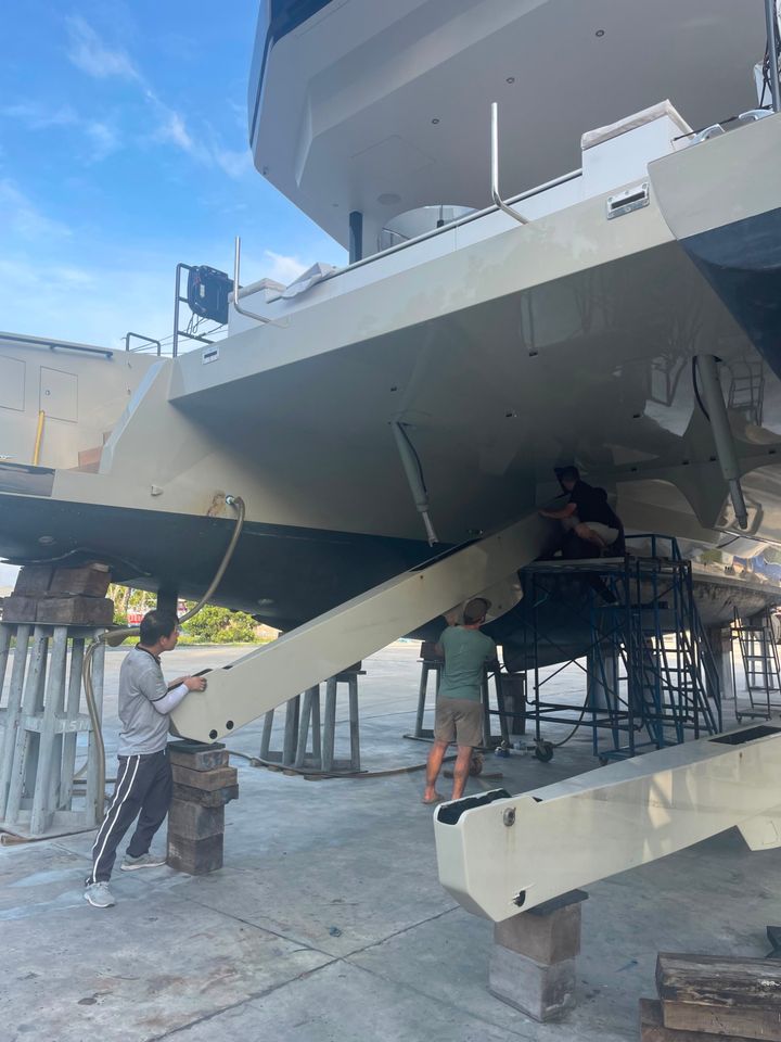 Crew working under the hull on the hardstand