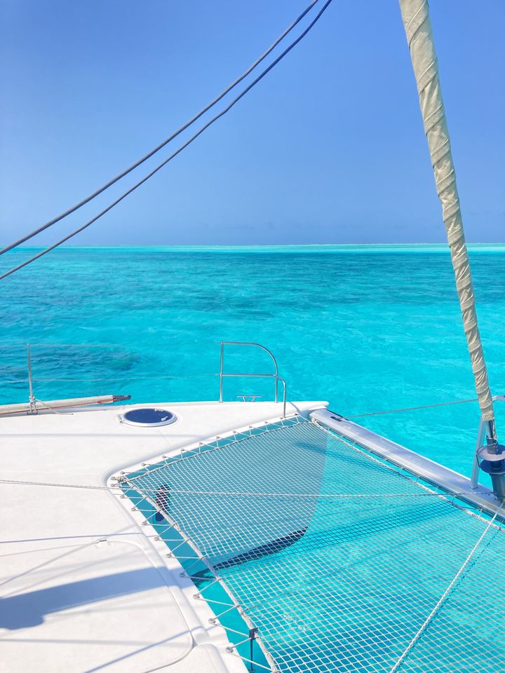 The trampoline on a catamaran above turquoise water